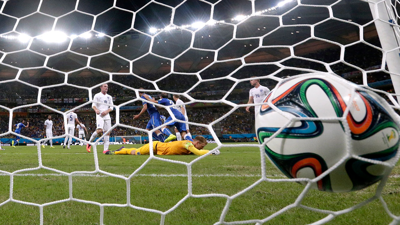 The ball bounces in the net after Italy's Claudio Marchisio scores the opening goal during the group D World Cup soccer match between England and Italy in Manaus, Brazil, Saturday, June 14, 2014.
