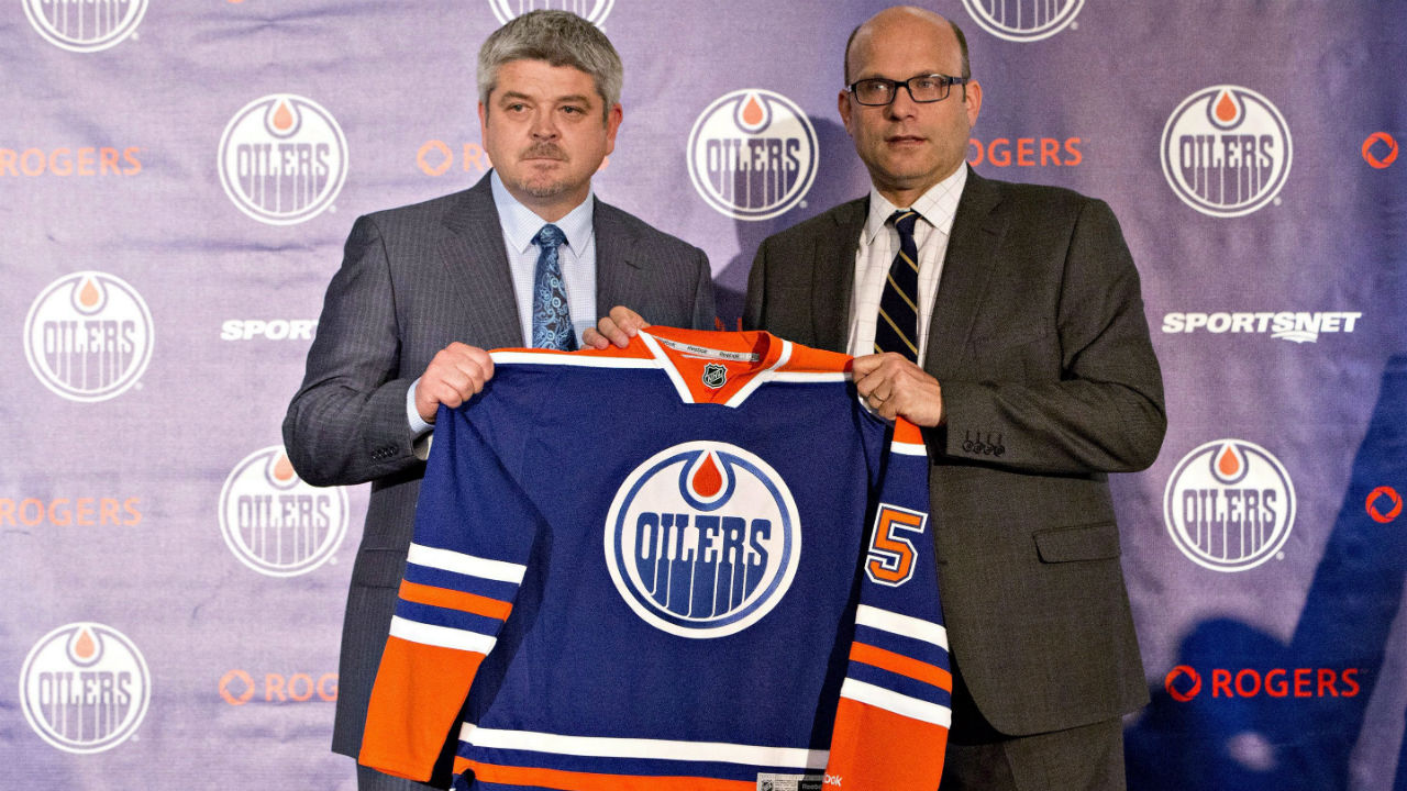 Todd McLellan, left, and Peter Chiarelli, President of Hockey Operations and General Manager of the Edmonton Oilers, hold up a jersey during a press conference after the Oilers announced McLellan as their new head coach in Edmonton, Alta., on Tuesday May 19, 2015. (Jason Franson/CP)