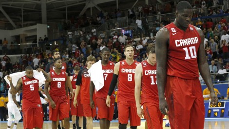 Anthony Bennett, right, leads the way as Canada leaves the court. (Julio Cortez/AP)