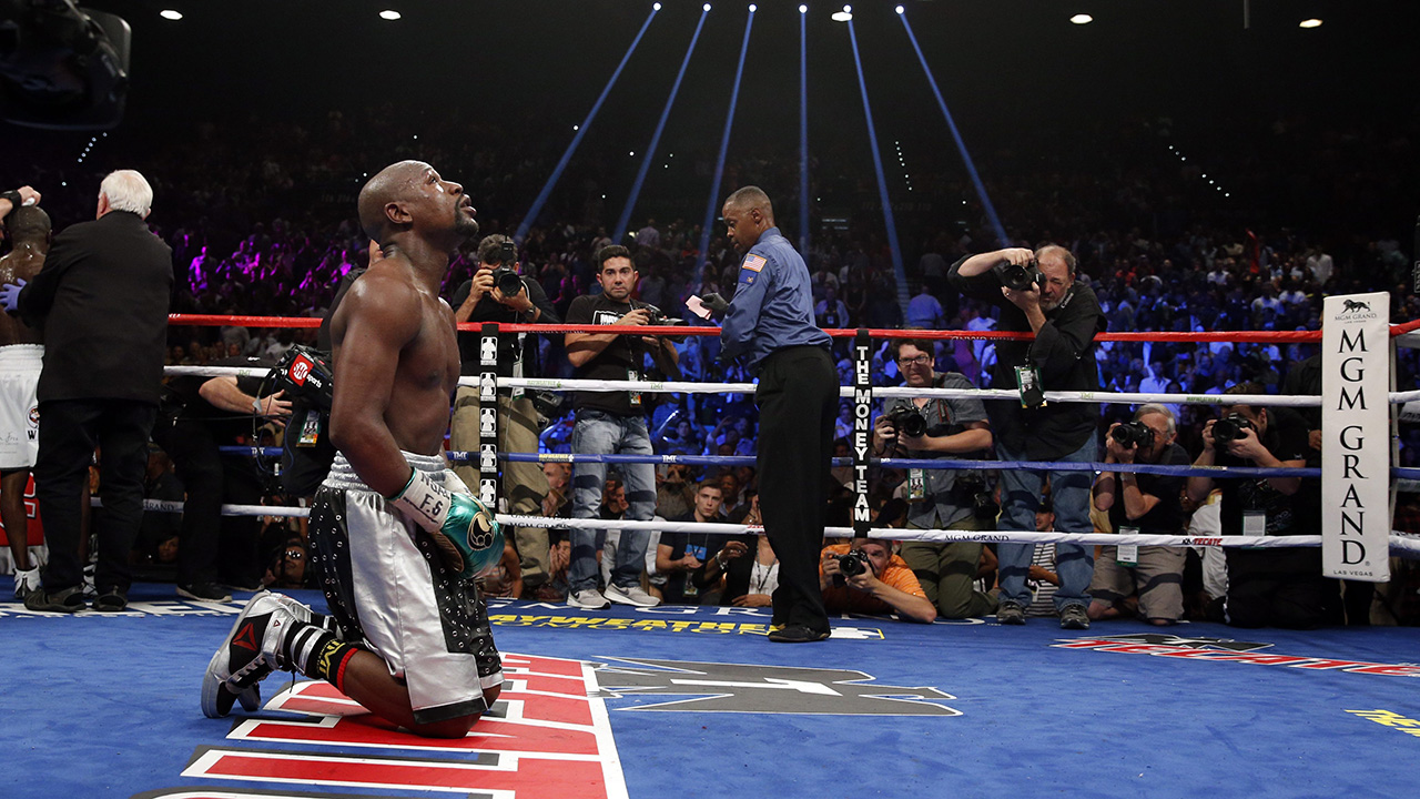 Floyd Mayweather Jr. kneels at the end of his welterweight title bout on Saturday in Las Vegas. (John Locher/AP)