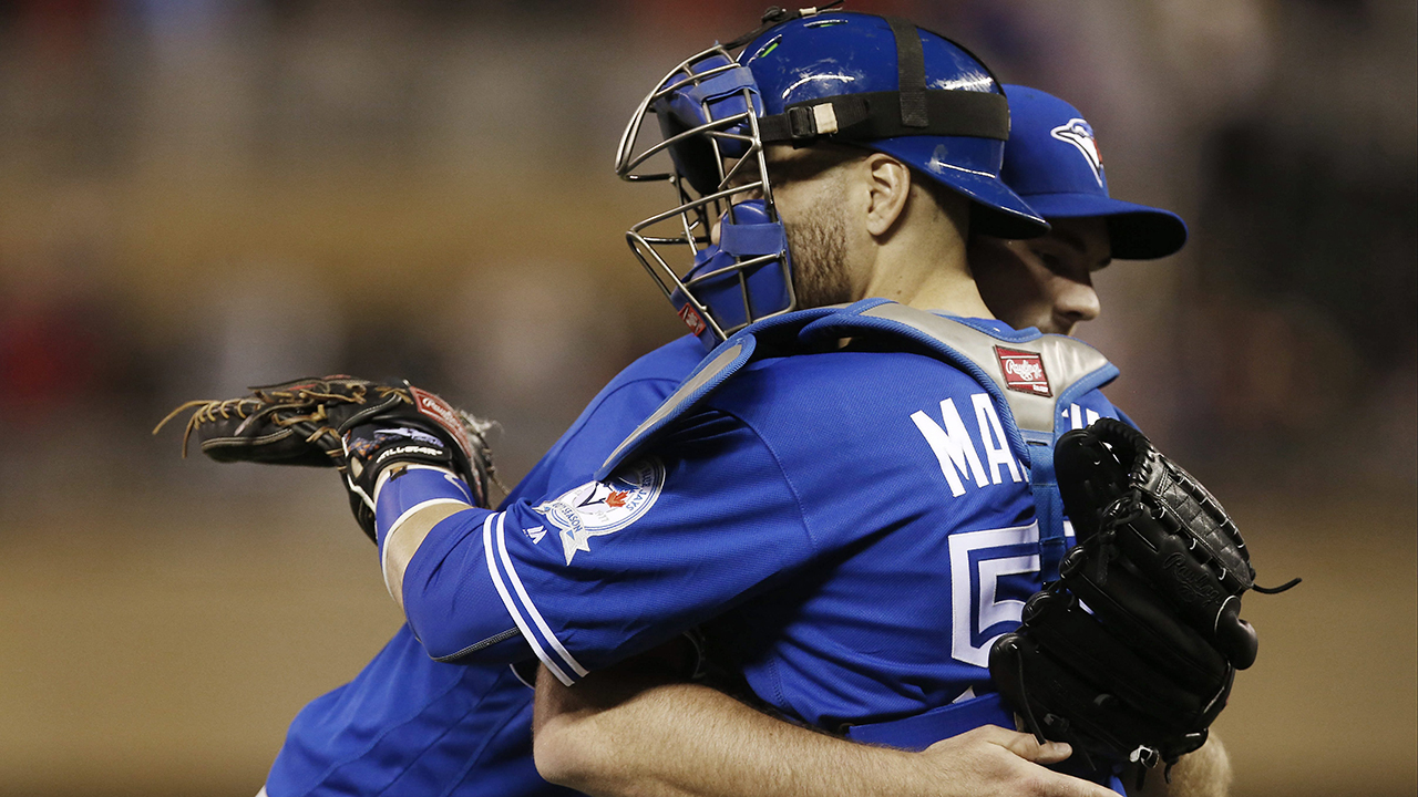 Russell Martin and reliever Joe Biagini embrace on the mound. (Jim Mone/AP)