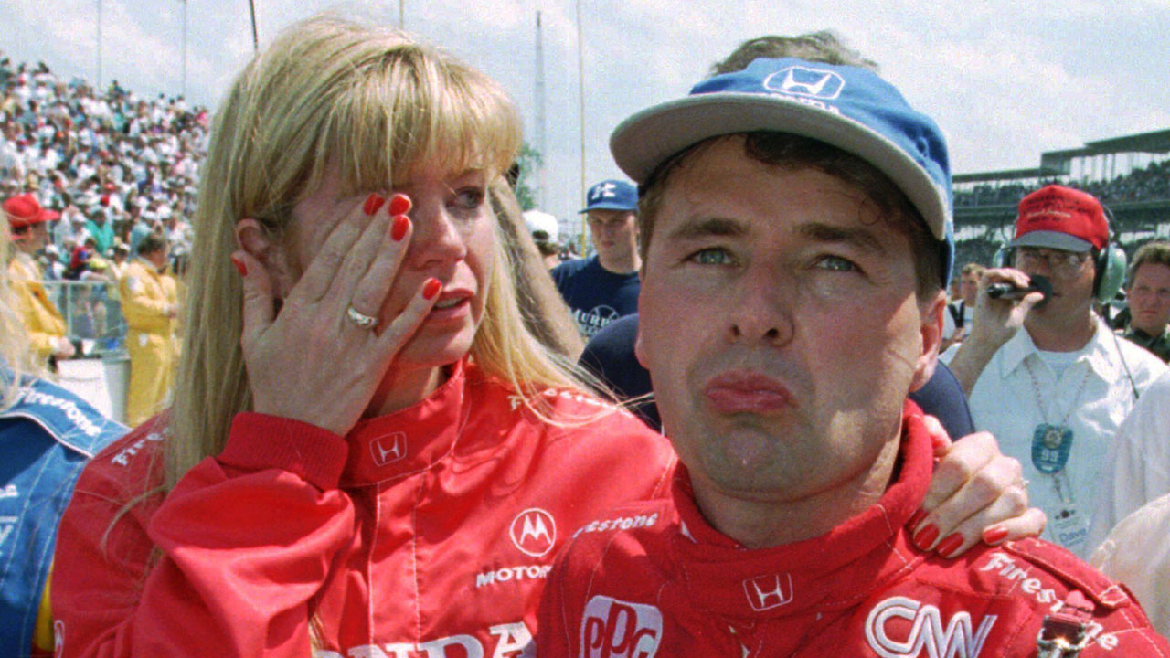 Scott Goodyear and his wife, Leslie, fight back tears after Goodyear was penalized for passing the pace car. (Michael Conroy/AP)