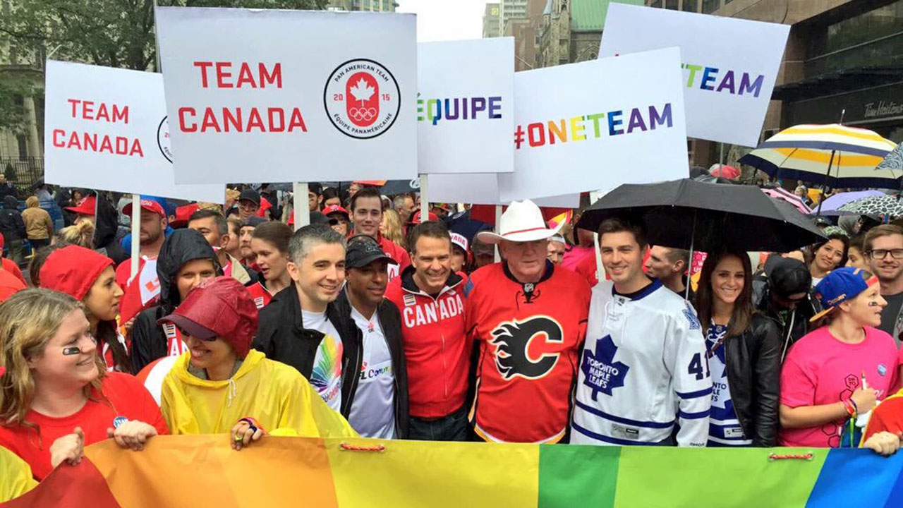 CFL commissioner Jeffrey Orridge poses for a picture at the 2015 Toronto Pride Parade, along with Patrick Burke (left) and Brian Burke (second from right). (Max Rosenberg)