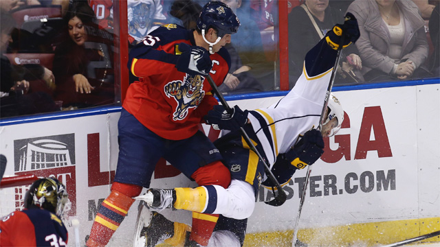 Florida Panthers' Ed Jovanovski (55) and Nashville Predators' Paul Gaustad (28) battle for the puck during the second period of a NHL hockey game in Sunrise, Fla., Saturday, Jan. 4, 2014. (AP Photo/J Pat Carter)