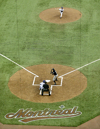 Montreal Expos former pitcher and now coach Claude Raymond, left, consoles  Brad Wilkerson as they say farewell to fans following the team's final home  game against the Florida Marlins in Montreal, Sept.