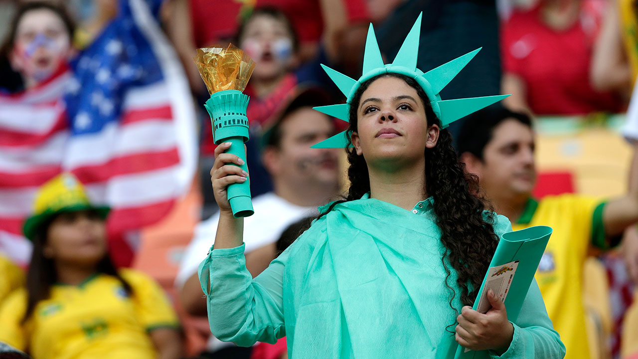 A United States supporter dressed as the Statue of Liberty waits for the start of the match between the U.S.A. and Portugal.