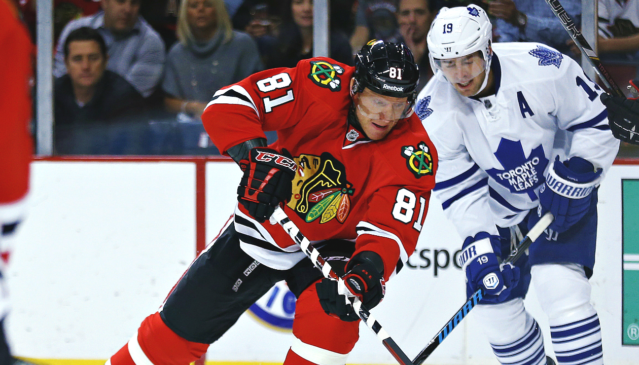 Chicago Blackhawks right wing Marian Hossa (81) advances past Toronto Maple Leafs left wing Joffrey Lupul (19) during the first period of an NHL hockey game Saturday, Oct. 19, 2013, in Chicago. (AP Photo/Andrew A. Nelles)