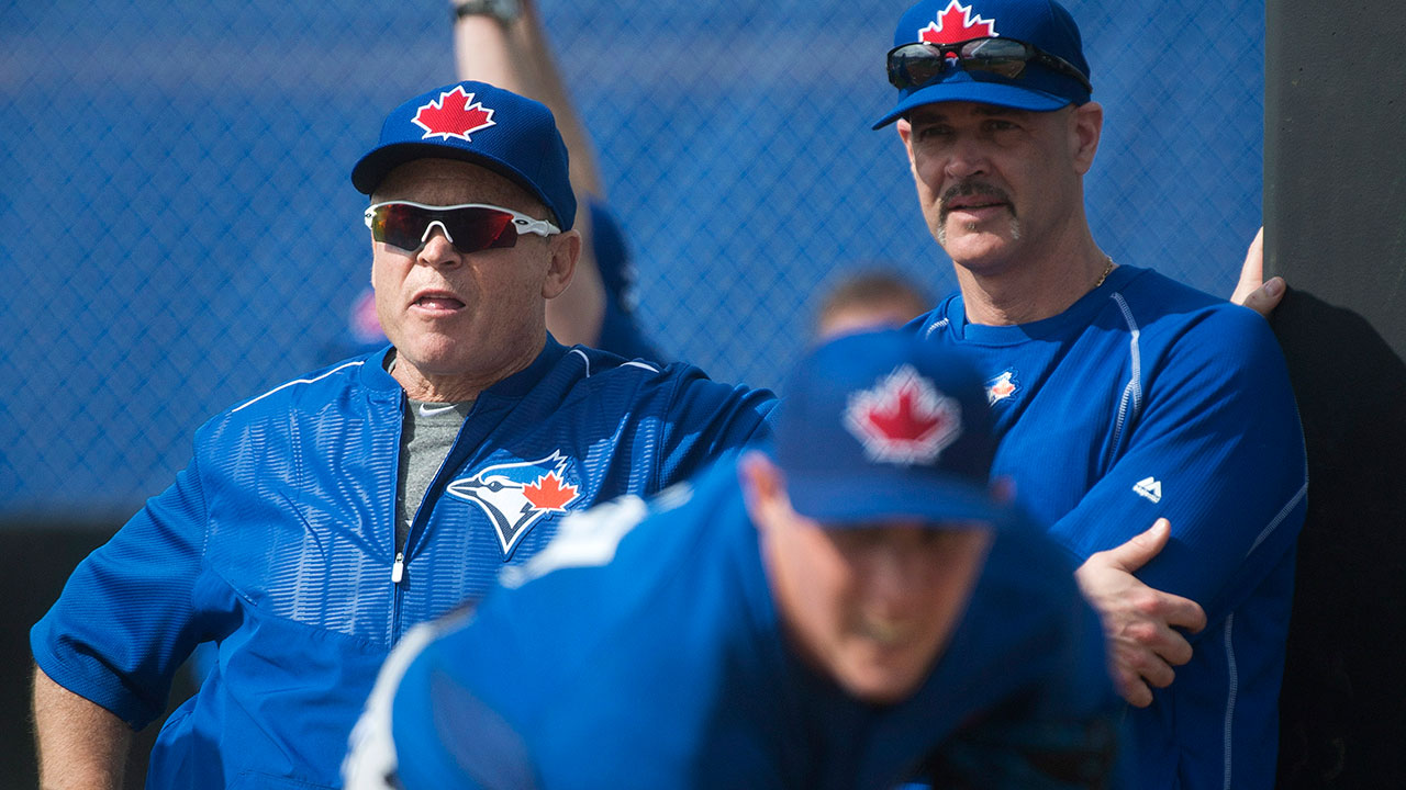 Toronto Blue Jays pitcher Aaron Sanchez, front, pitches in the bullpen as Blue Jays manager John Gibbons, left, and pitching coach Pete Walker, right, watch during baseball spring training in Dunedin, Fla., on February 24, 2015. (Nathan Denette/CP)