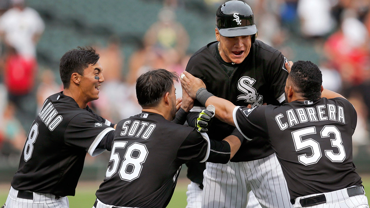 Chicago White Sox's Avisail Garcia, center, celebrates with teammates Tyler Saladino, left, Geovany Soto (58) and Melky Cabrera (53) after Garcia drew a bases loaded walk. (Charles Rex Arbogast/AP)