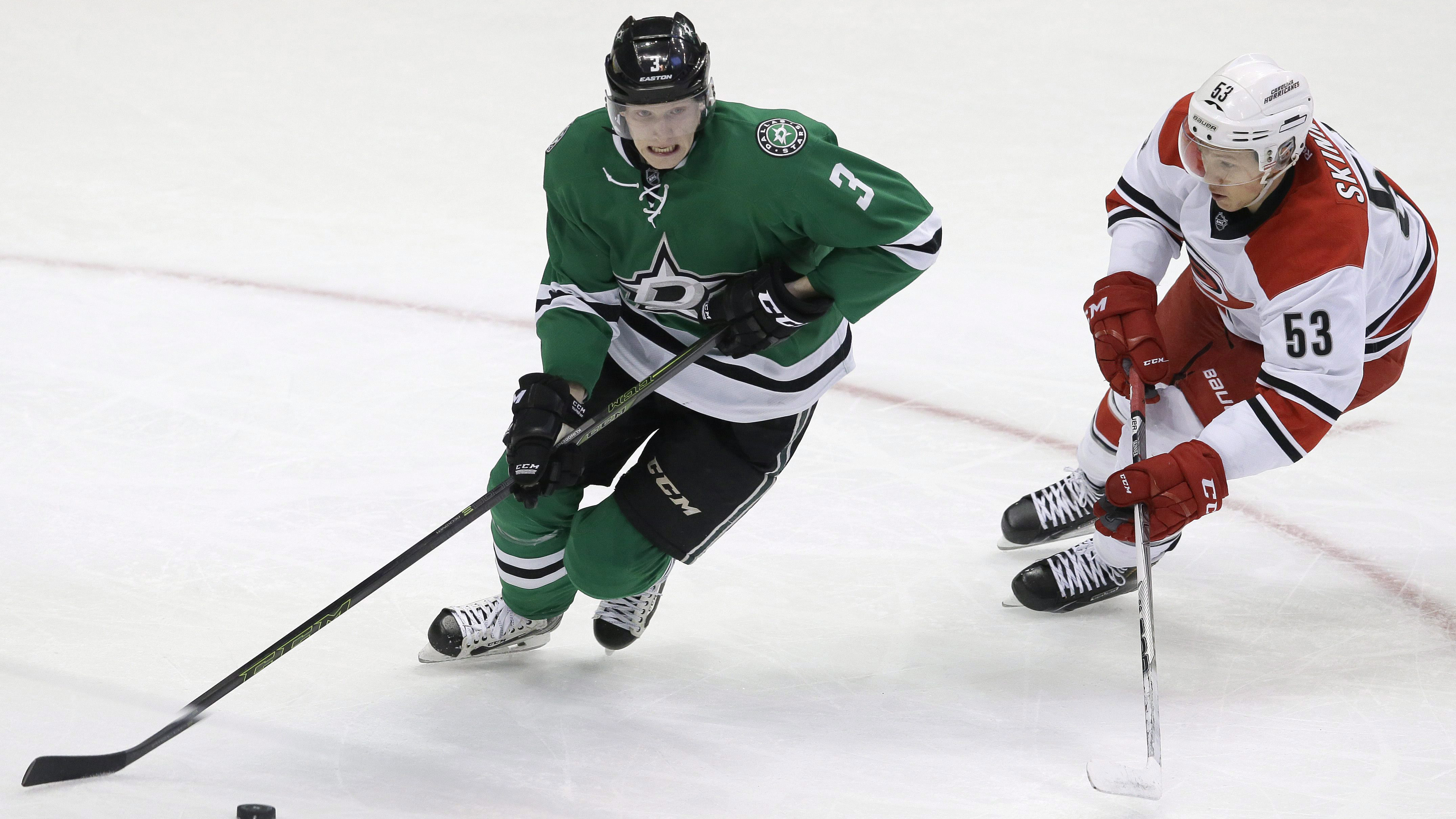 Stars defenceman John Klingberg (3) skates with the puck against Hurricanes left wing Jeff Skinner (53), both players have yet to play in the NHL playoffs. (LM Otero/AP)