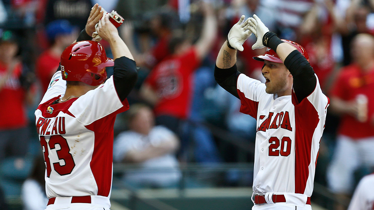 Morneau, left, and Michael Saunders pictured as teammates for Team Canada. (Ross D. Franklin/AP)