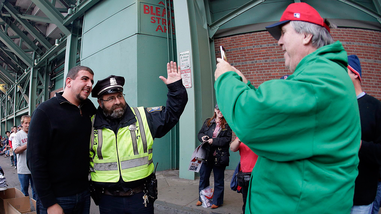 Andrew Durham, right, photographs Boston police officer Steve Horgan. (Charlie Riedel/AP)