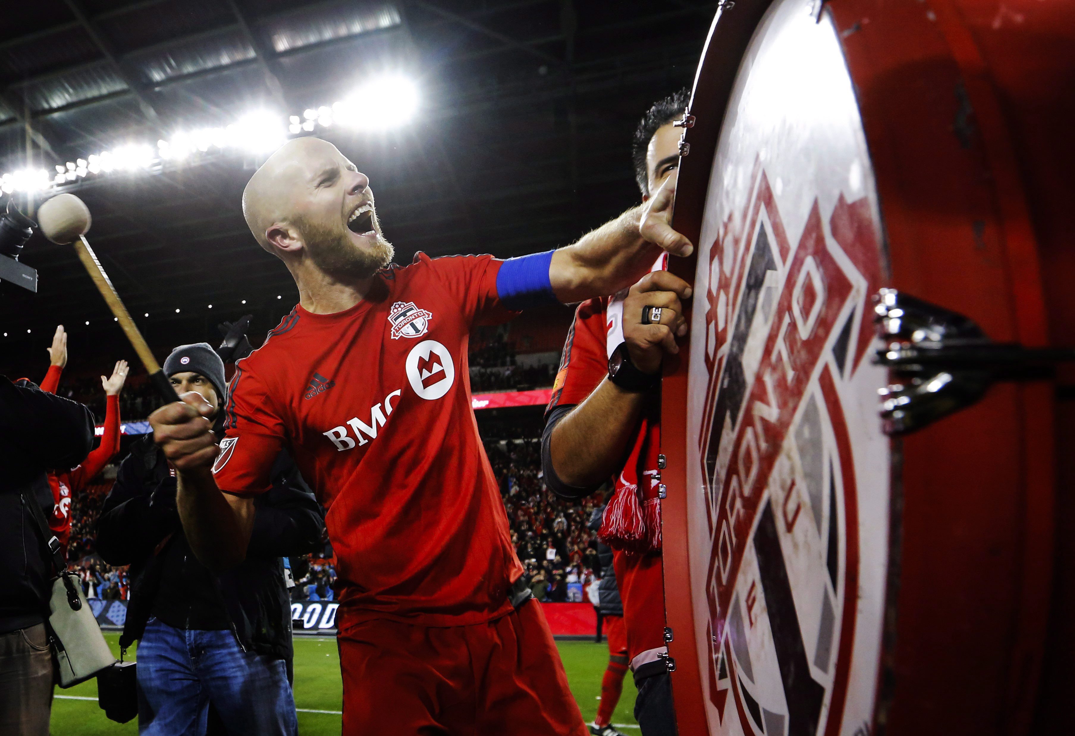 Toronto FC midfielder Michael Bradley bangs on a drum after his team defeated the Philadelphia Union in MLS soccer playoff action in Toronto, Wednesday October 26, 2016. (Mark Blinch/CP)