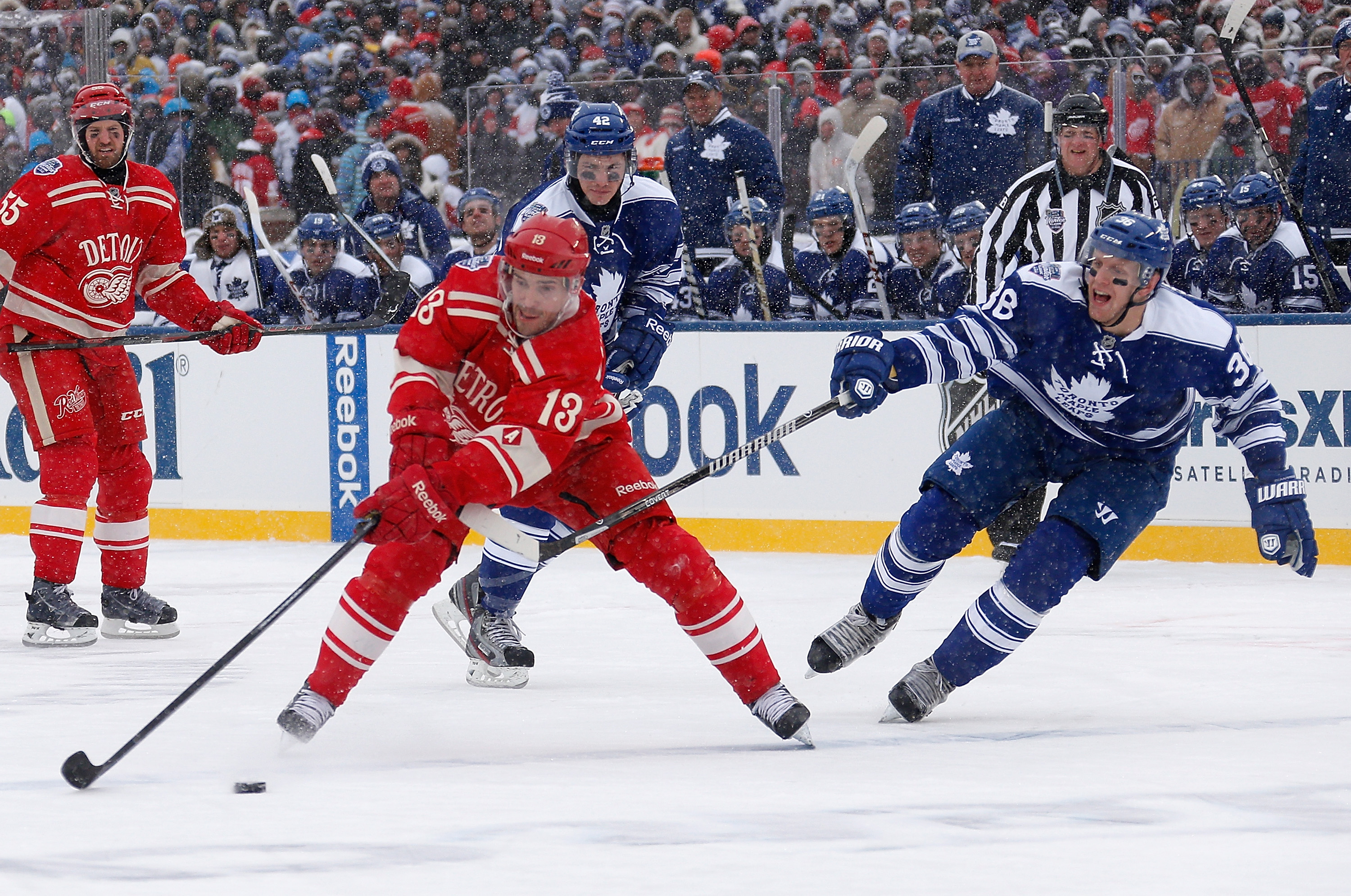 ANN ARBOR, MI - JANUARY 01: Pavel Datsyuk #13 of the Detroit Red Wings looks to avoid Frazer McLaren #38 of the Toronto Maple Leafs in the second period during the 2014 Bridgestone NHL Winter Classic at Michigan Stadium on January 1, 2014 in Ann Arbor, Michigan. (Photo by Gregory Shamus/Getty Images)