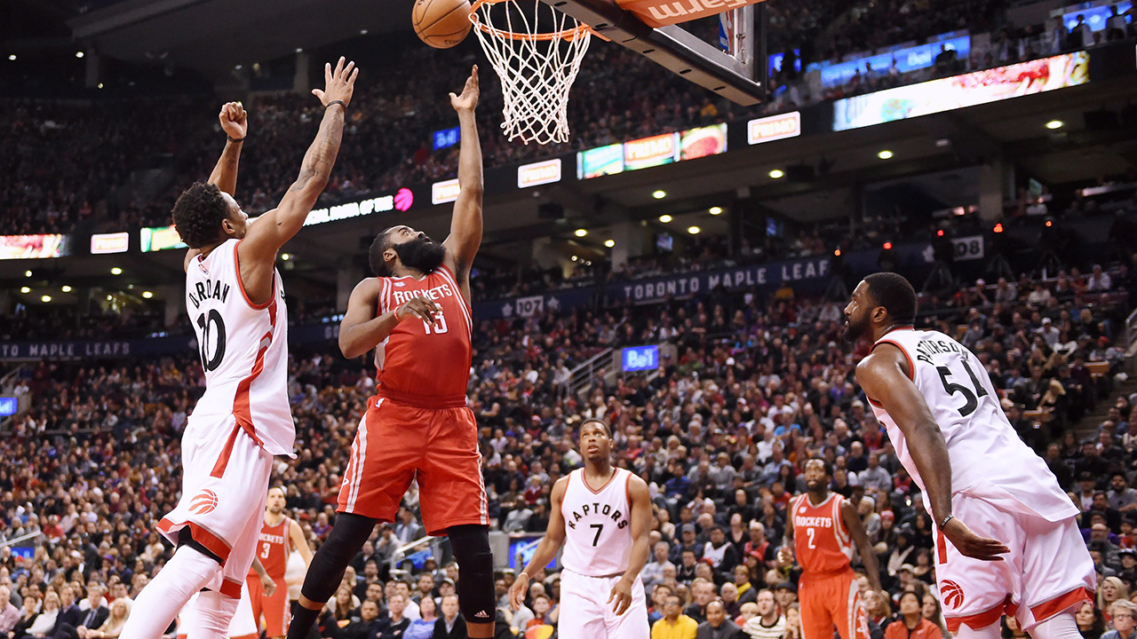 Houston Rockets guard James Harden (13) scores as Toronto Raptors guard DeMar DeRozan (10) defends and guard Kyle Lowry (7) and forward Patrick Patterson (54) look on during second half. (Frank Gunn/CP)