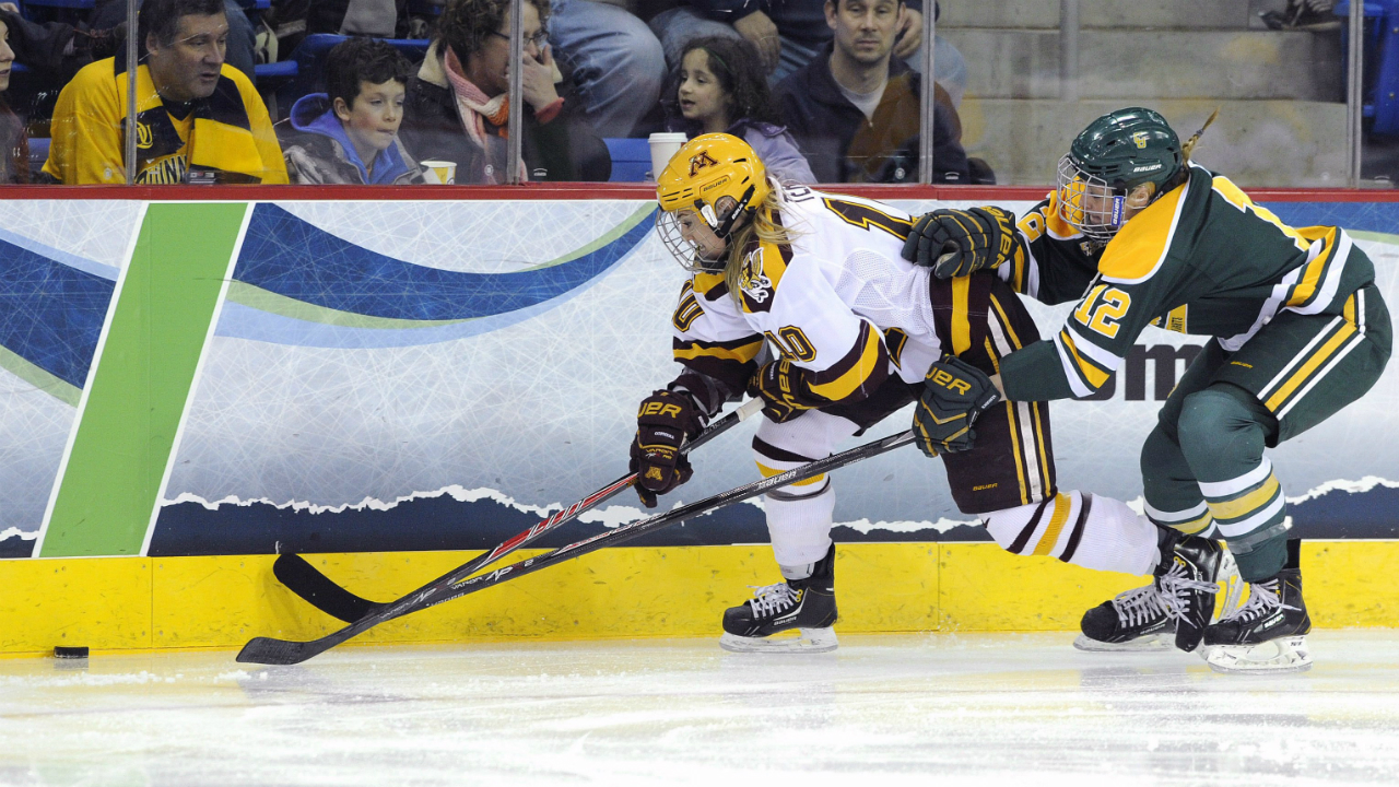 Renata Fast, left, fights for a puck as a member of the Clarkson Golden Knights during the finals of the Women's Frozen Four in Hamden, Conn., Sunday, March 23, 2014. (Fred Beckham/AP)
