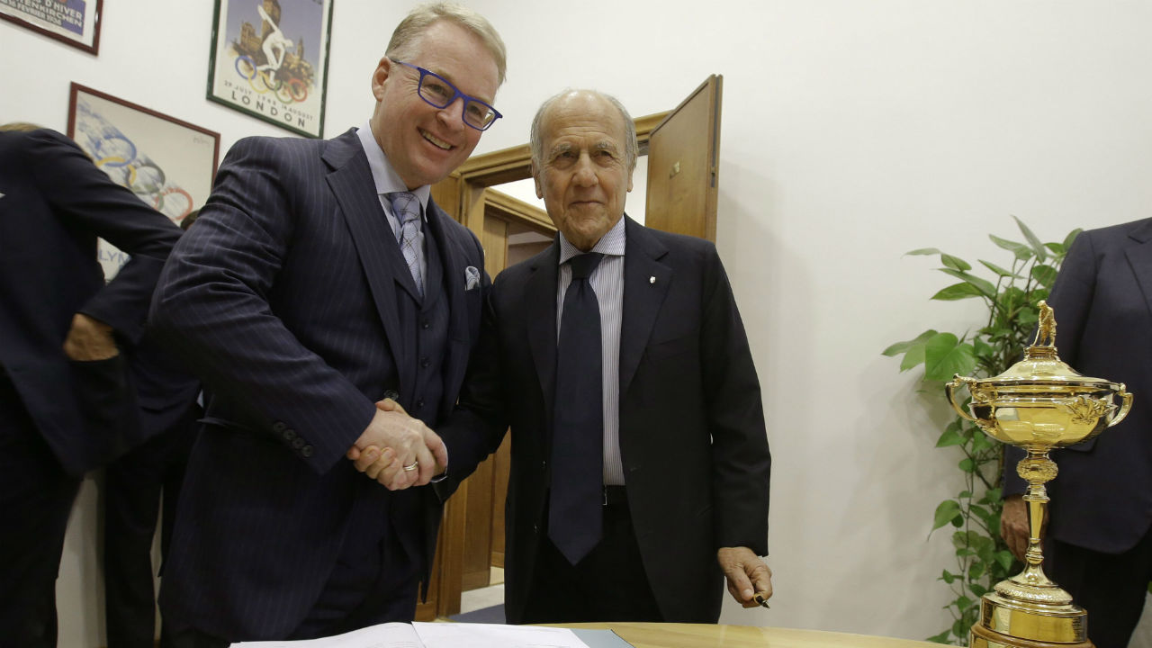 Franco Chimenti, right, president of the Italian Golf Federation, and Keith Pelley, CEO of the European Tour, shake hands next to the Ryder Cup trophy, in Rome, Wednesday, Dec. 16, 2015. The Ryder Cup is headed to Italy for the first time. (Gregorio Borgia/AP)