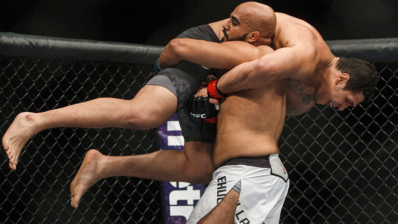 Luis Henrique is lifted by Arjan Bhullar during their mixed martial arts bout at UFC 215 in Edmonton.