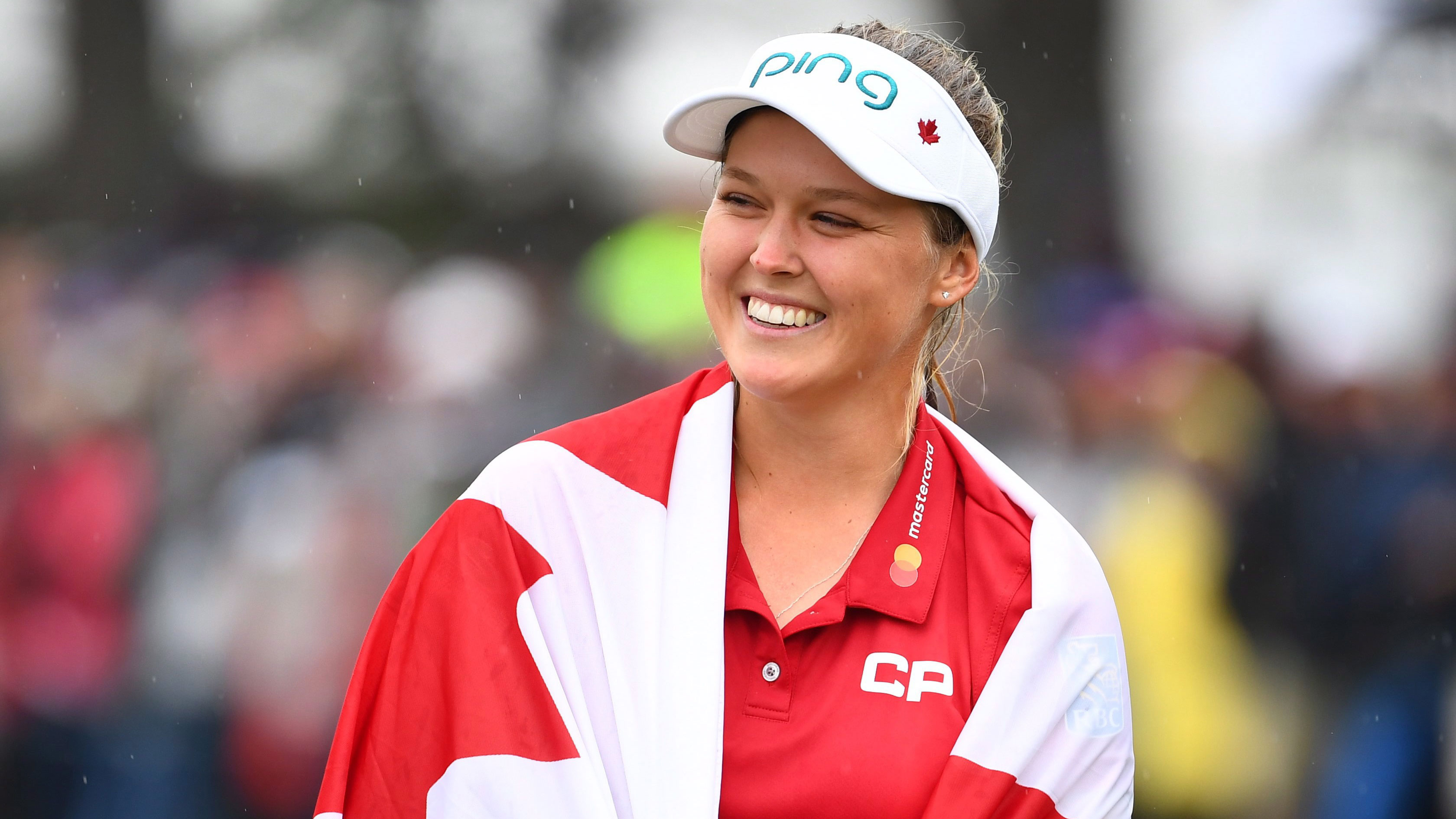 Canada’s Brooke Henderson, wrapped in a Canadian flag, celebrates her historic win at the CP Women's Open